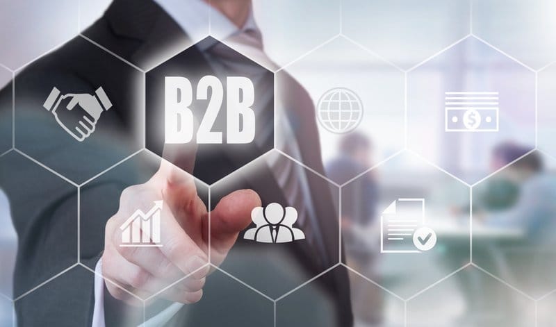 Businessman pressing a B2B concept button.
